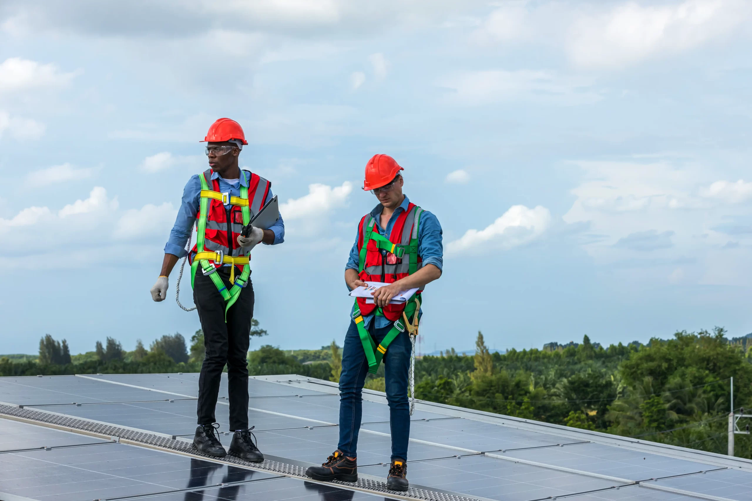 Technicians inspecting a solar panel installation