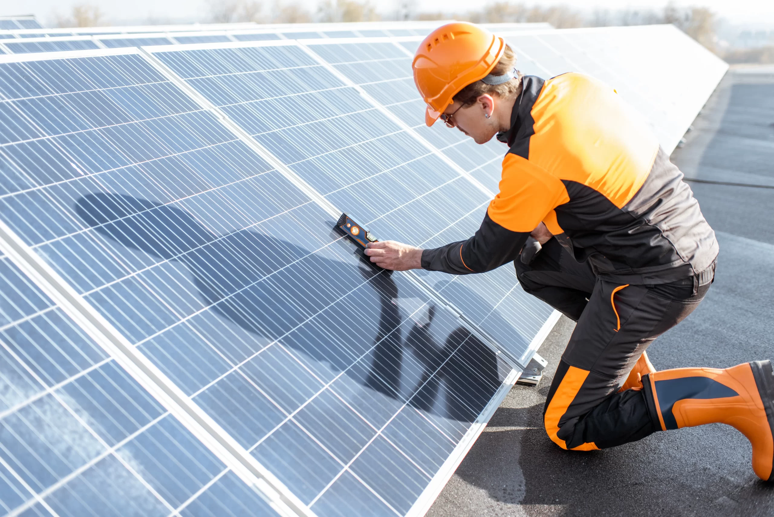 Technician inspecting solar panels