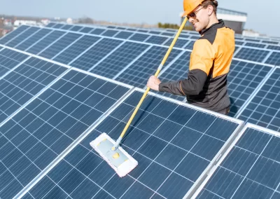 Technician cleaning solar panels