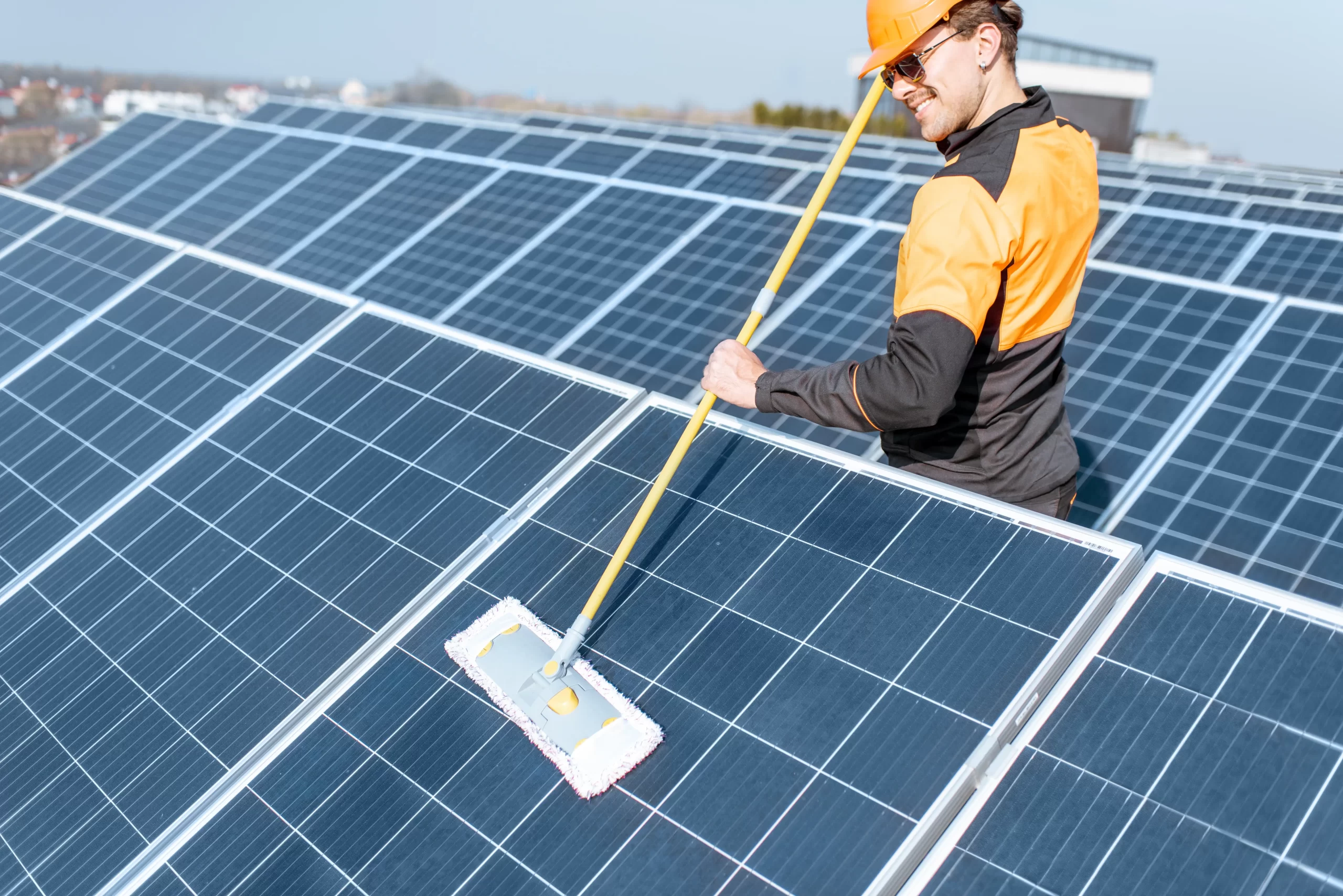 Technician cleaning solar panels